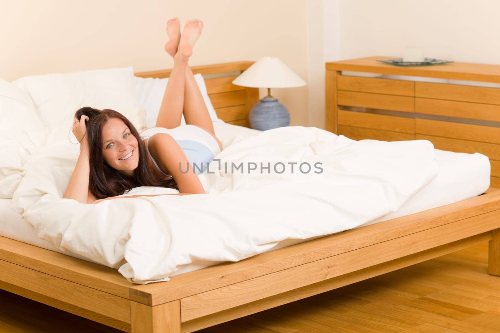 Bedroom - beautiful woman morning waking up lying on white bed