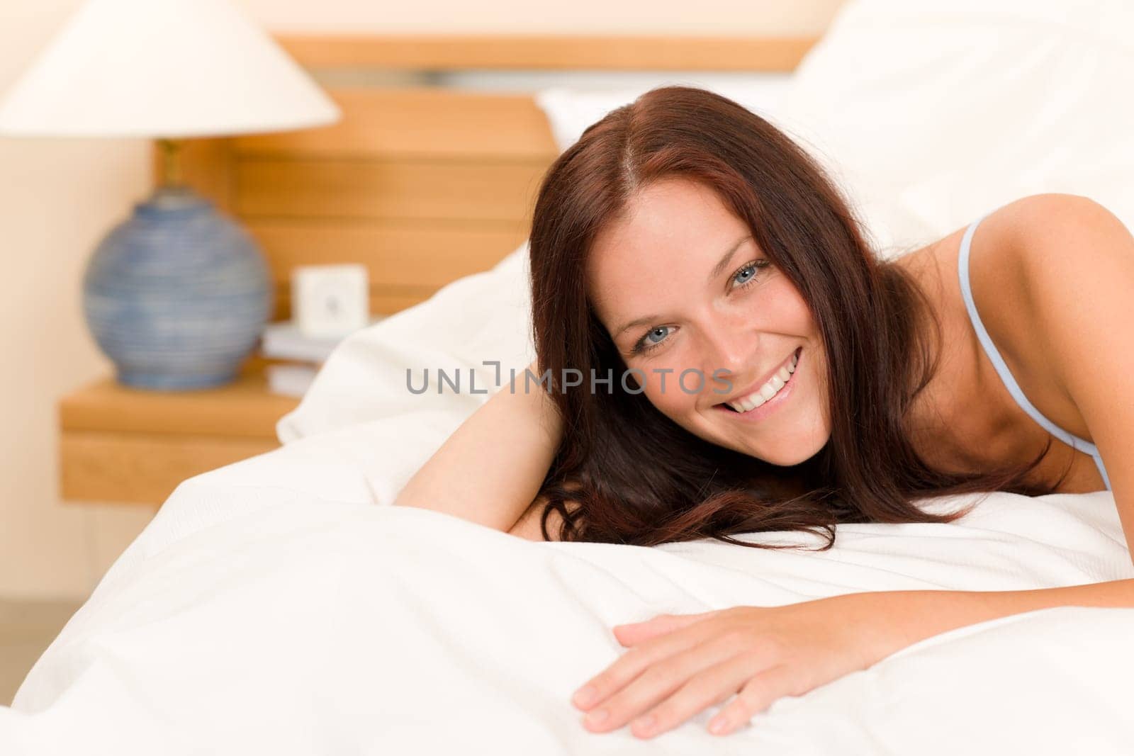 Bedroom - beautiful woman morning waking up lying on white bed