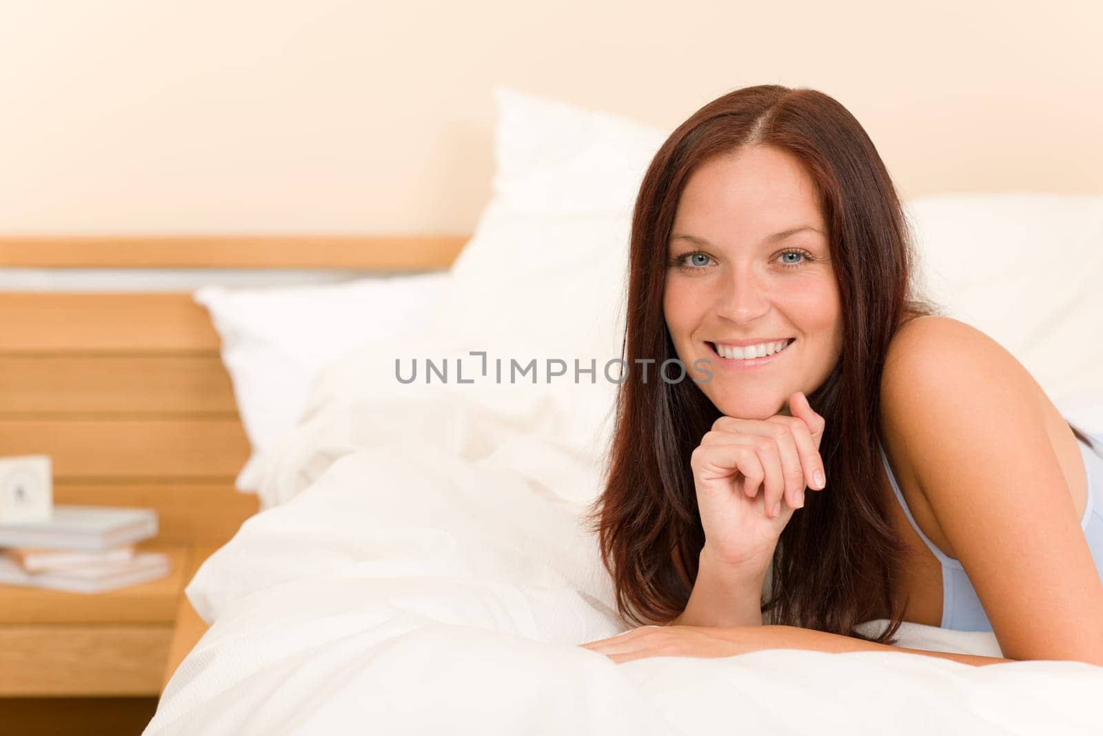 Bedroom - beautiful woman morning waking up lying on white bed