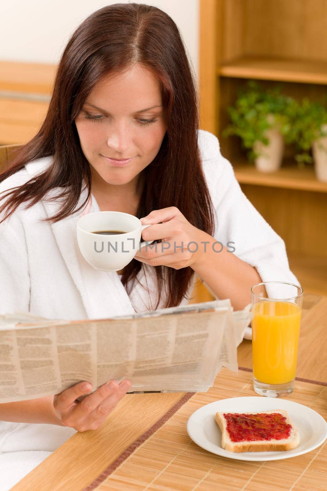 Breakfast coffee and toast happy woman read newspapers at home