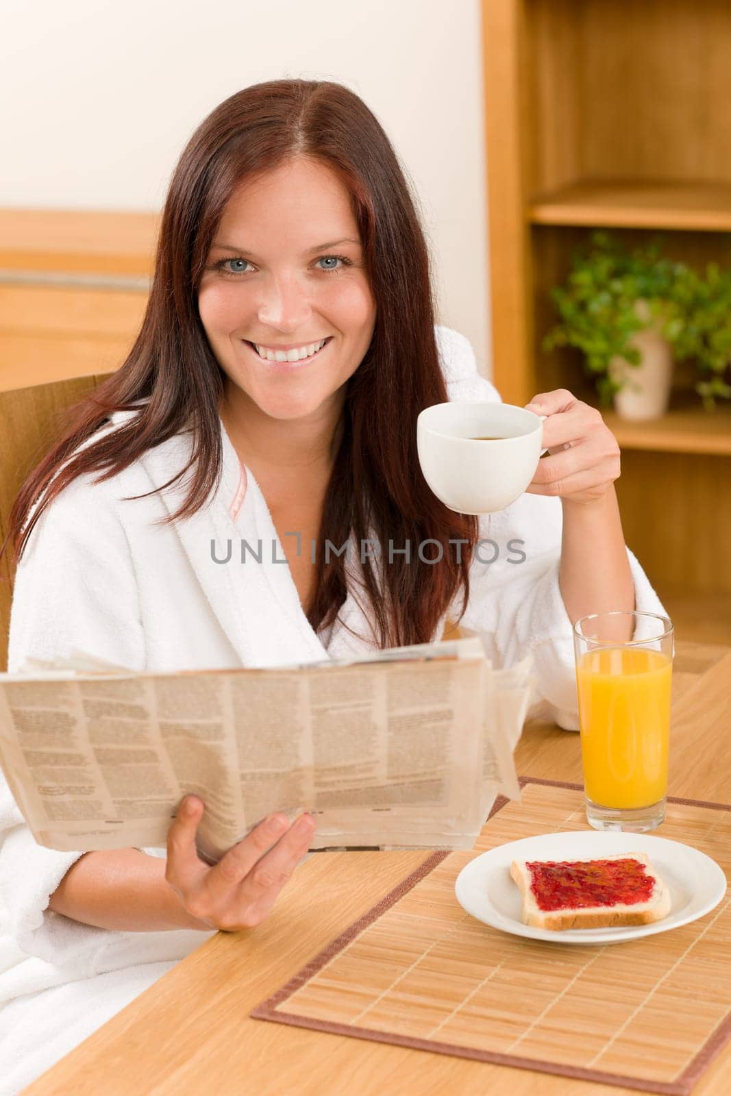Breakfast coffee and toast happy woman read newspapers at home
