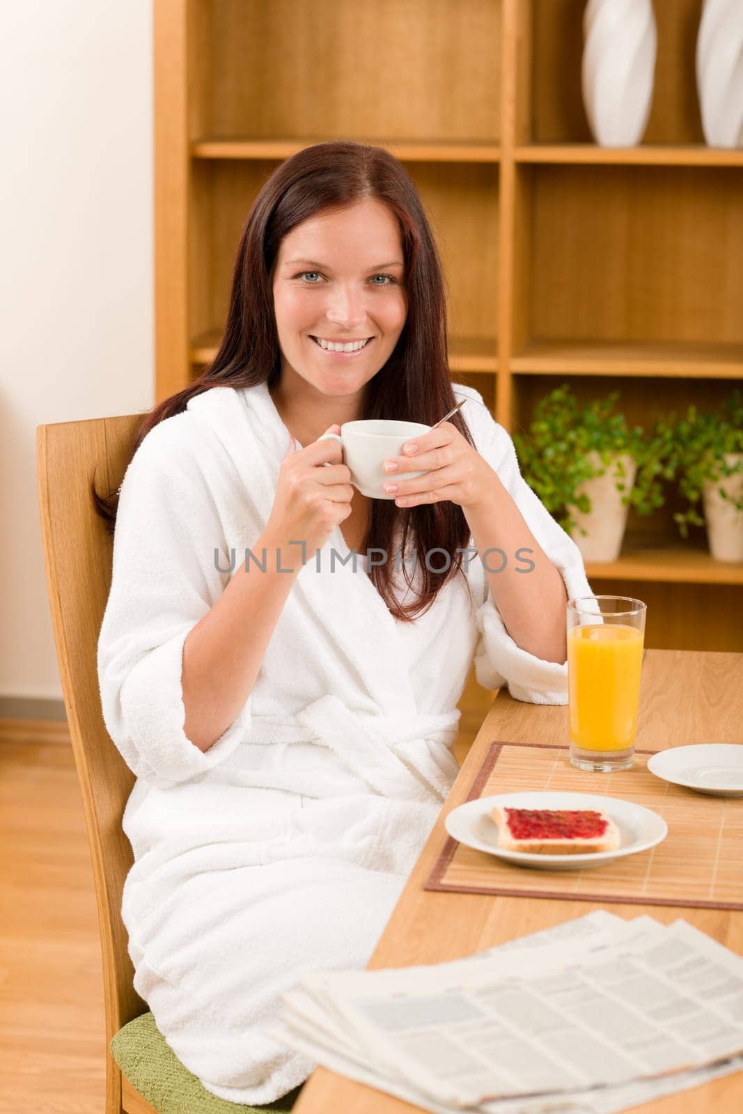 Breakfast coffee and toast happy woman in home bathrobe