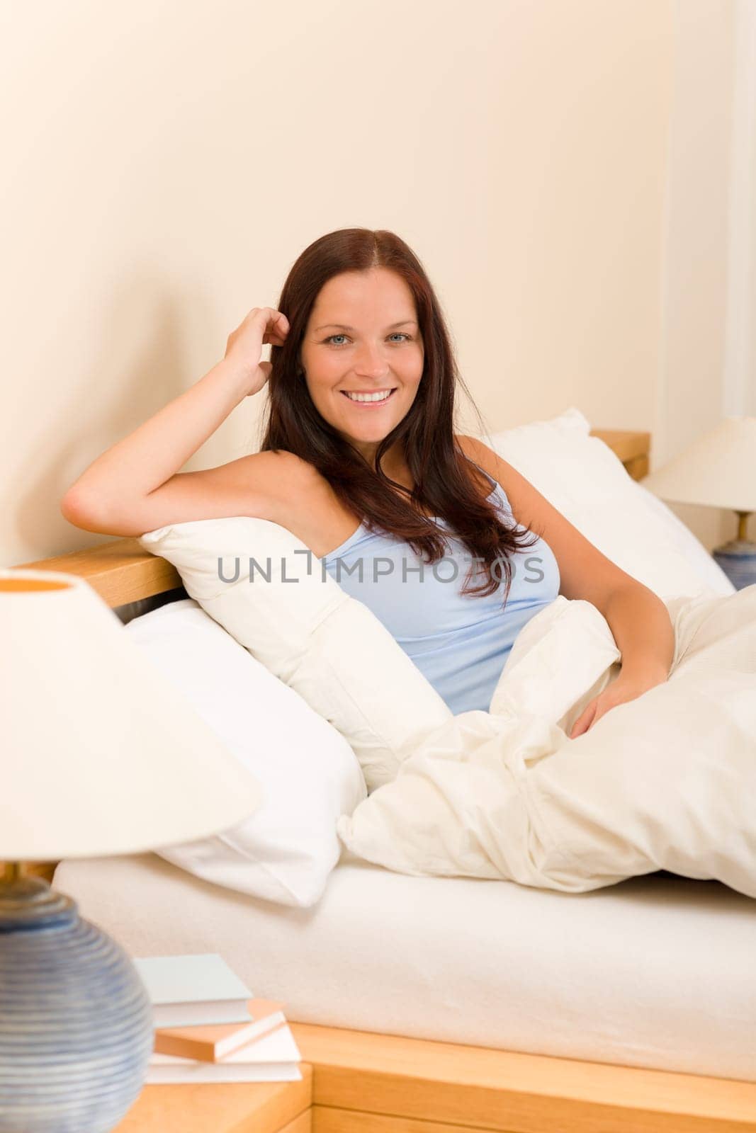 Bedroom - beautiful woman morning waking up sitting on white bed