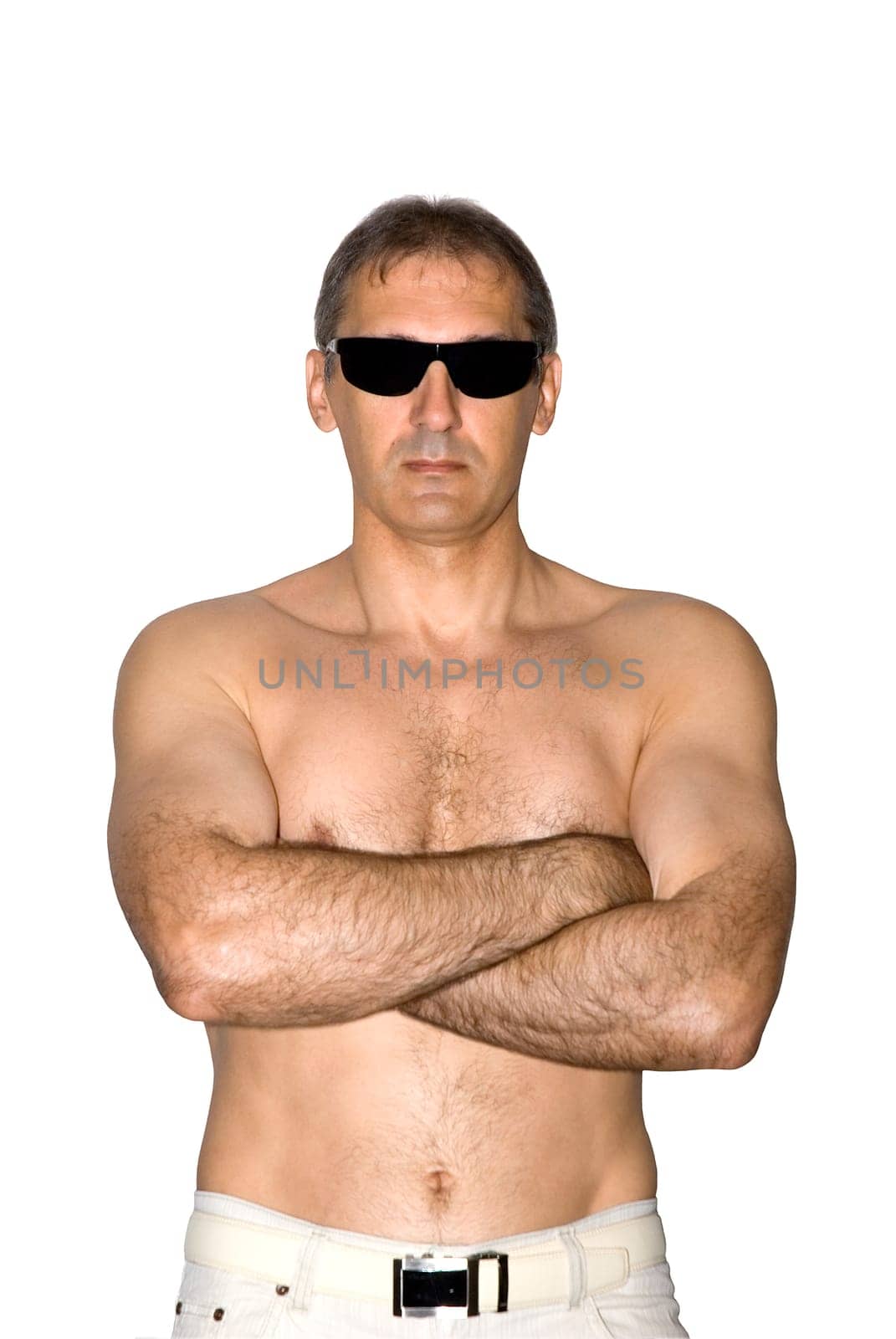 The brawny  man a poses before a camera