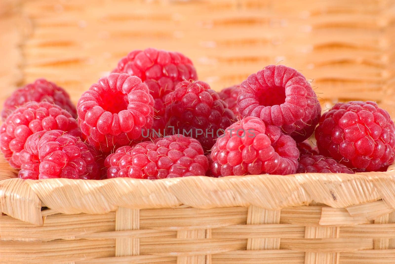 The bast-basket with a raspberry is photographed a close-up