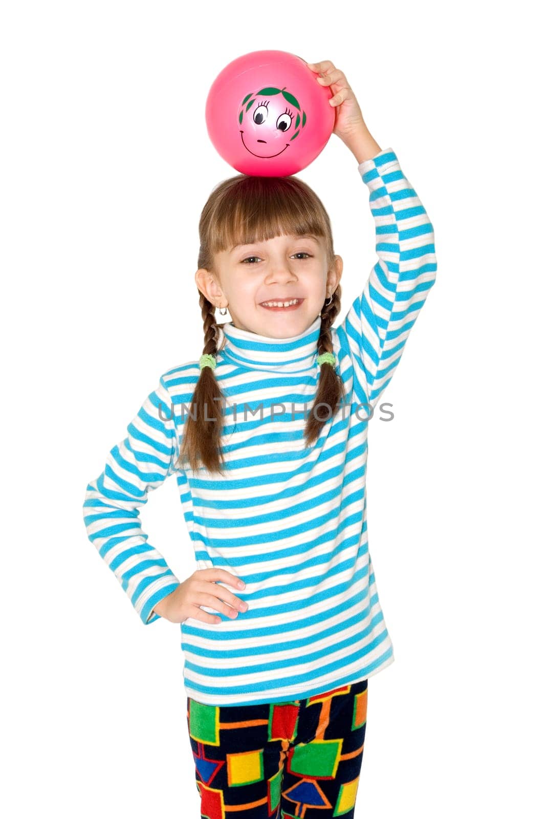 The girl in a striped blouse holds a pink ball on a head