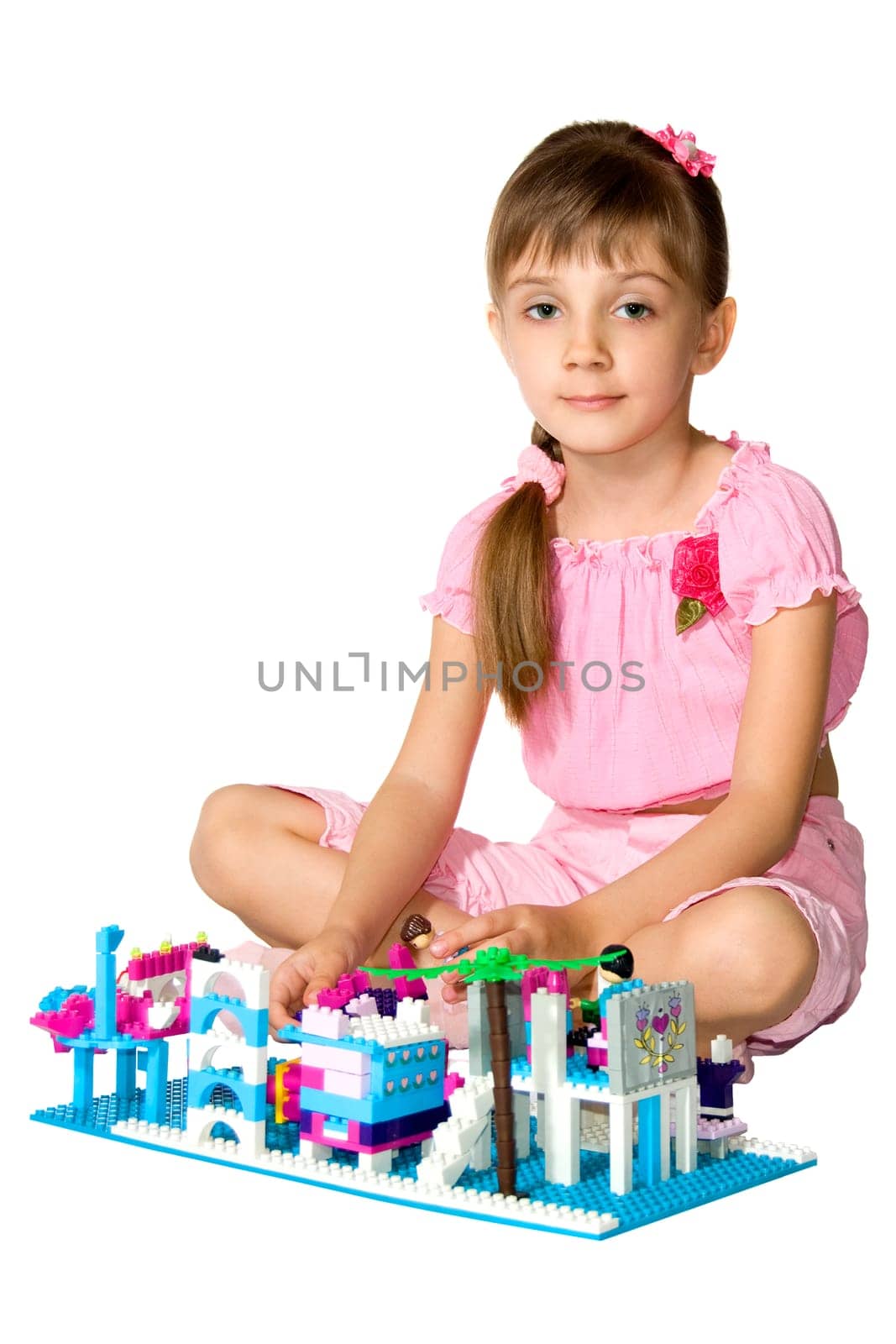 The little girl playing with the meccano