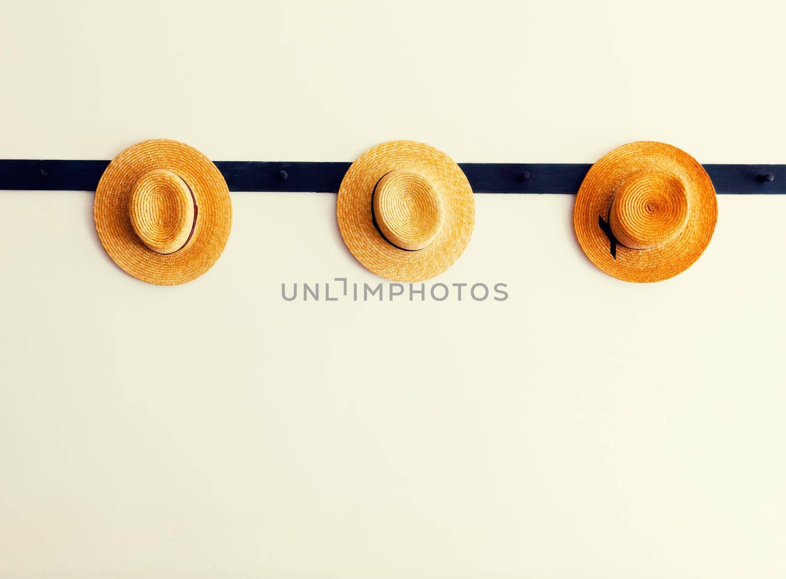 Shaker hats hanging on a peg rail