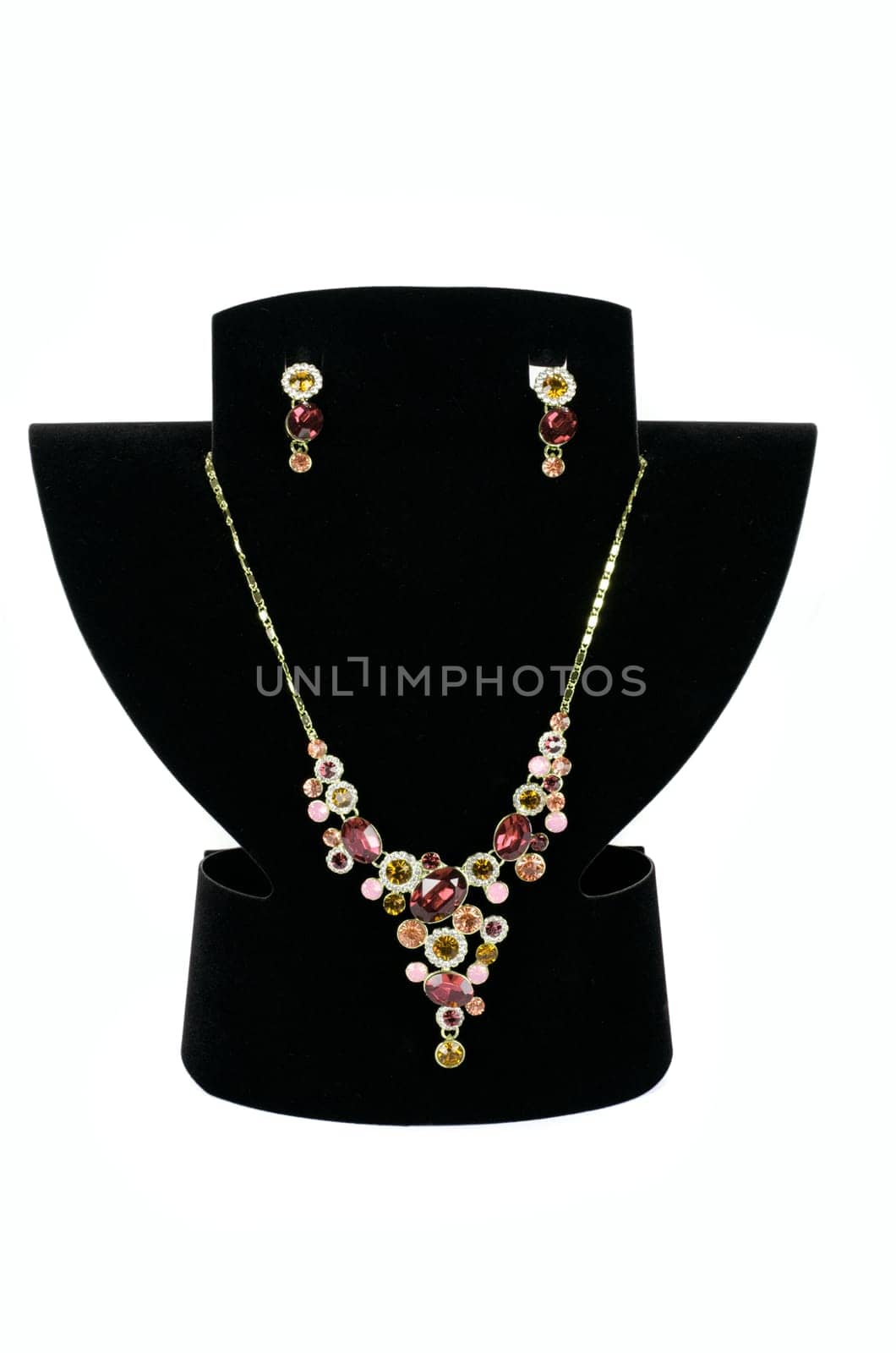 a necklace with pendants and earrings on a white background