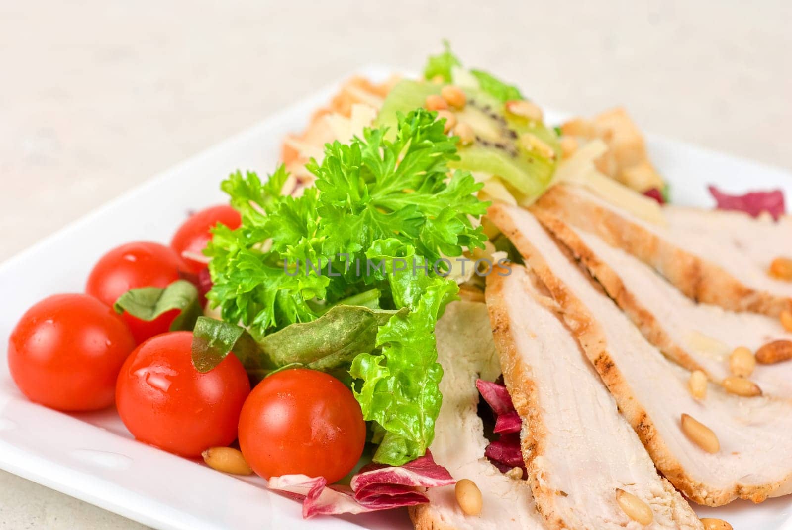 Tasty appetizer of meat, cherry tomato, greens and groundnut