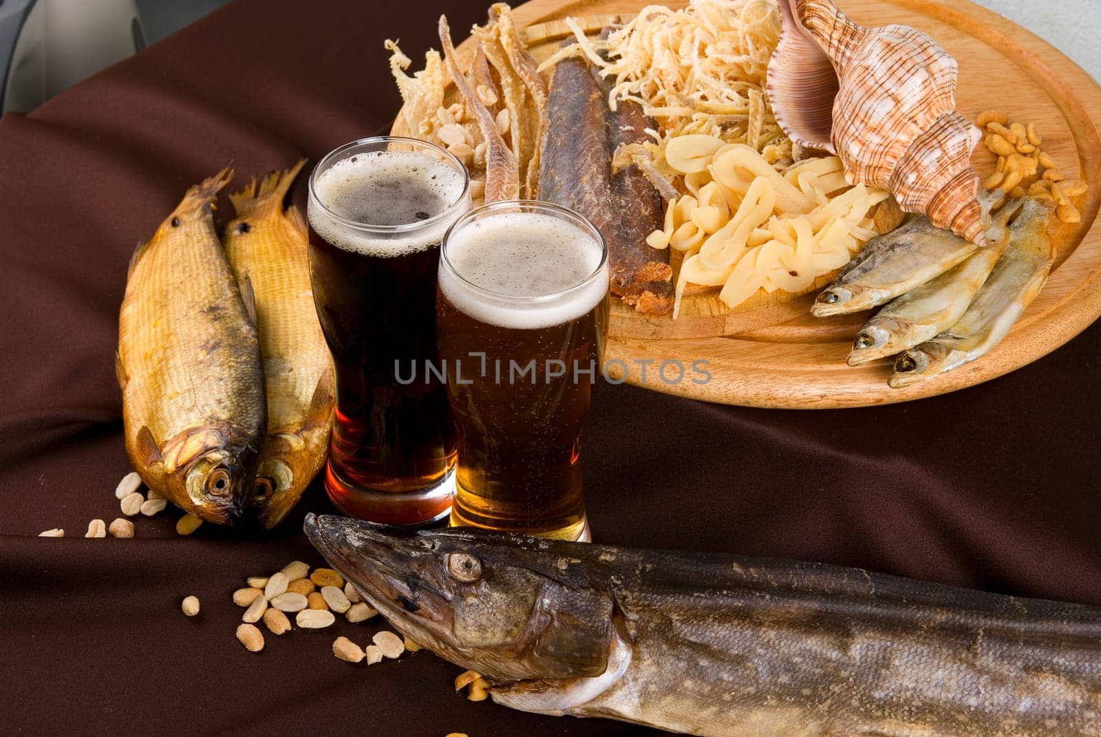Beer and snacks set: chips, pistachio, shrimp and fish