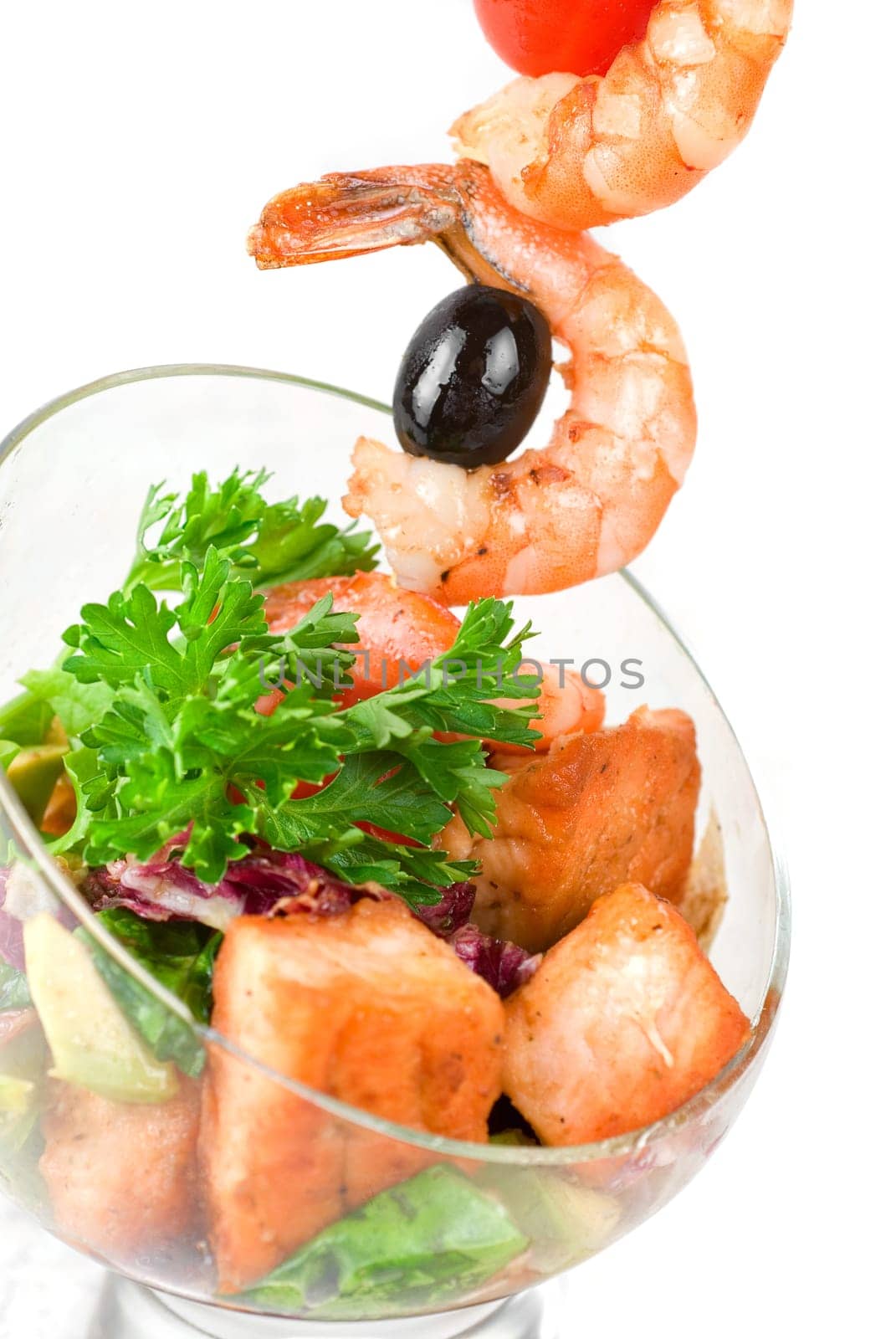Fried kebab of shrimps with vegetables, greens and salmon fish