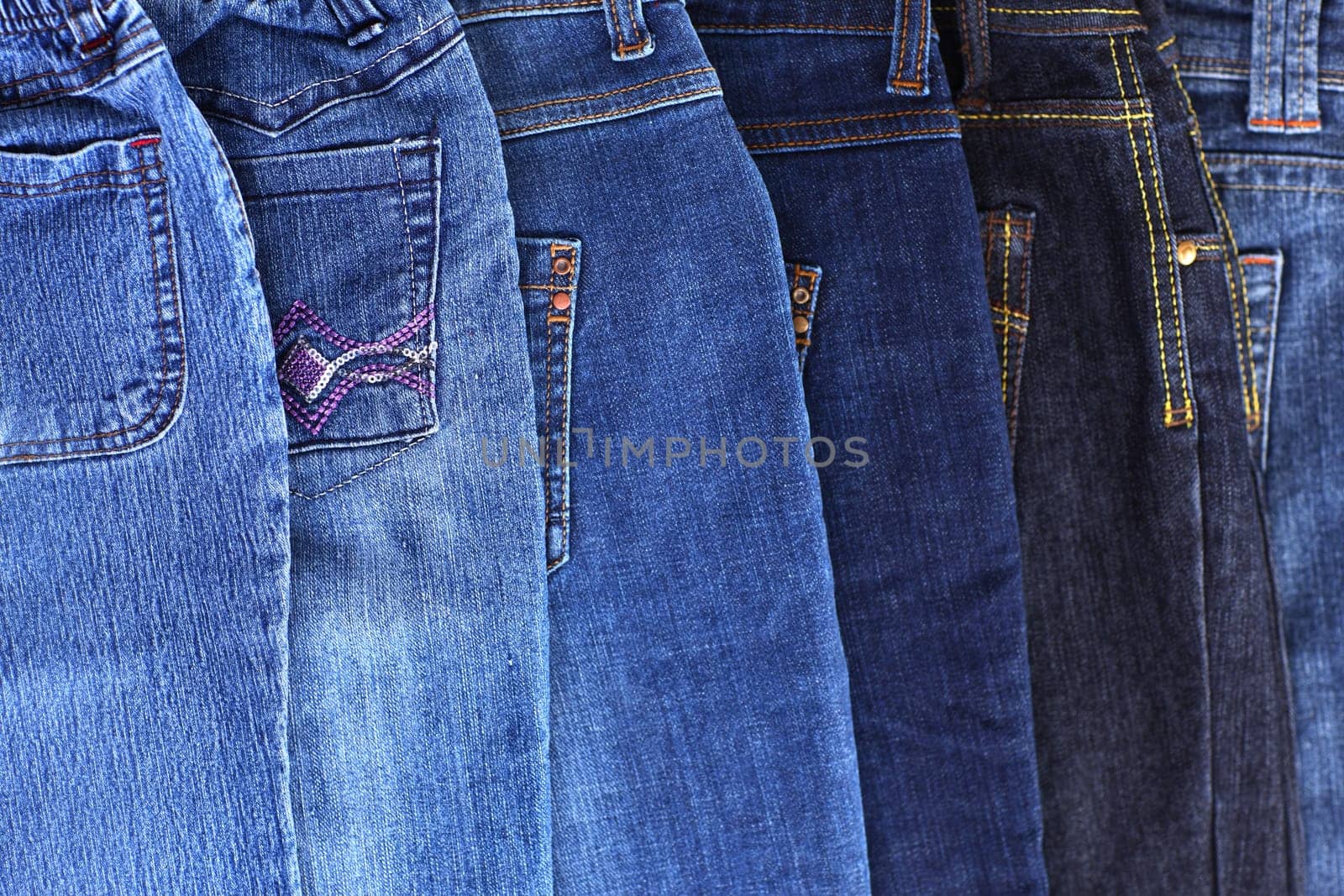 Stack of different jeans - detail
