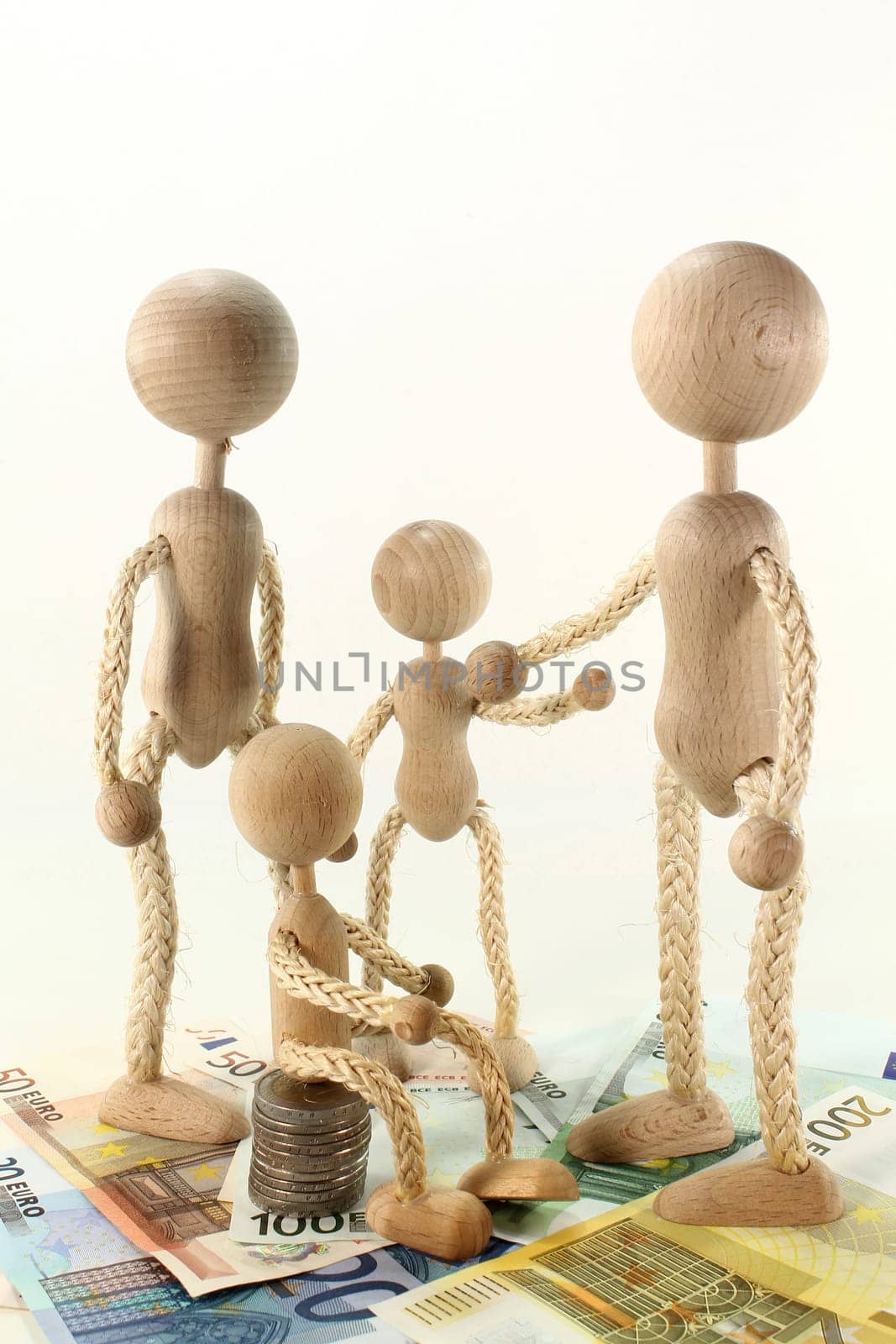 a family of wooden dolls and euro bills
