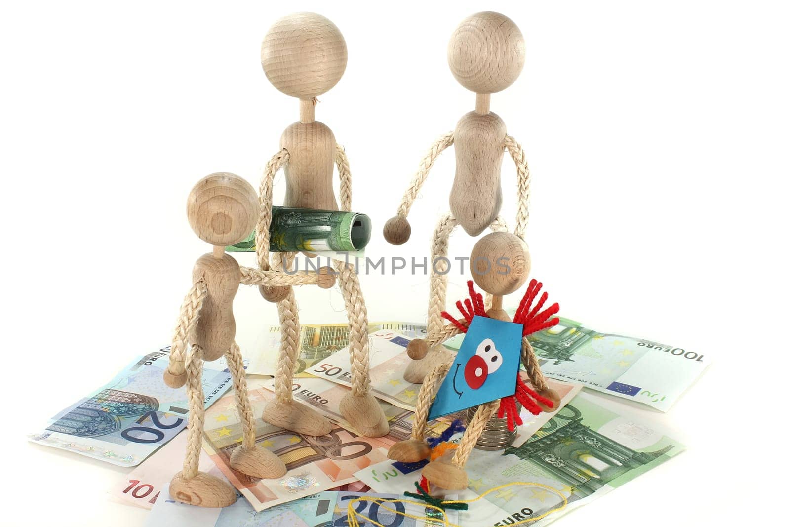 a family of wooden dolls and euro bills