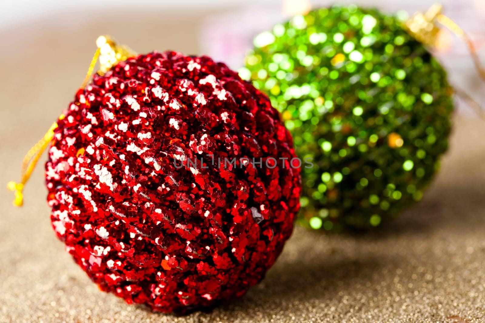 Close-up of sparkling green and red Christmas baubles