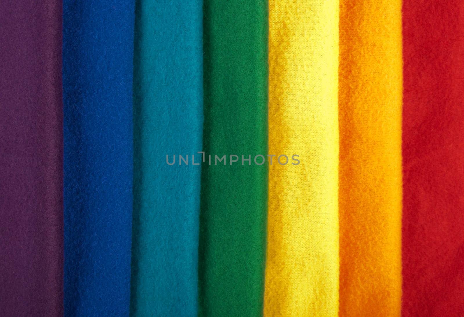 Rainbow background made of colorful winter scarfs