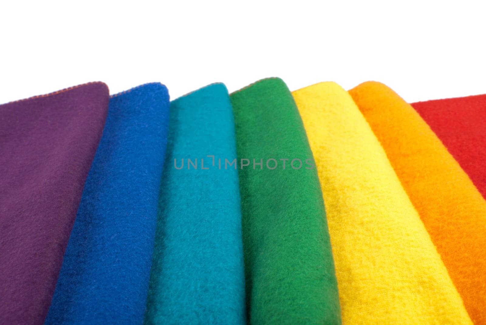 Colorful stack of scarfs in rainbow colored order. Isolated on white background