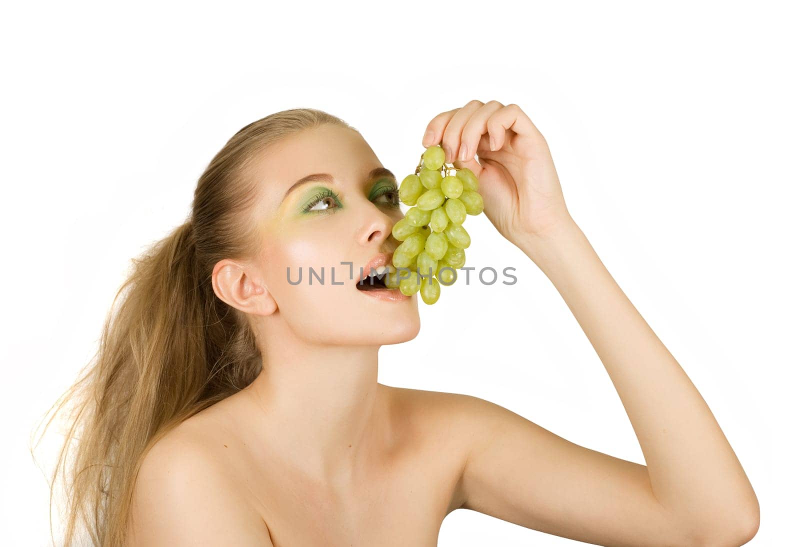 Pretty young woman with grape on the white background