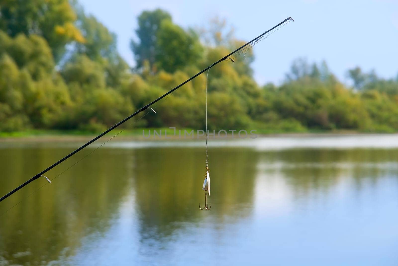fishing rod at lake. summer sunny day