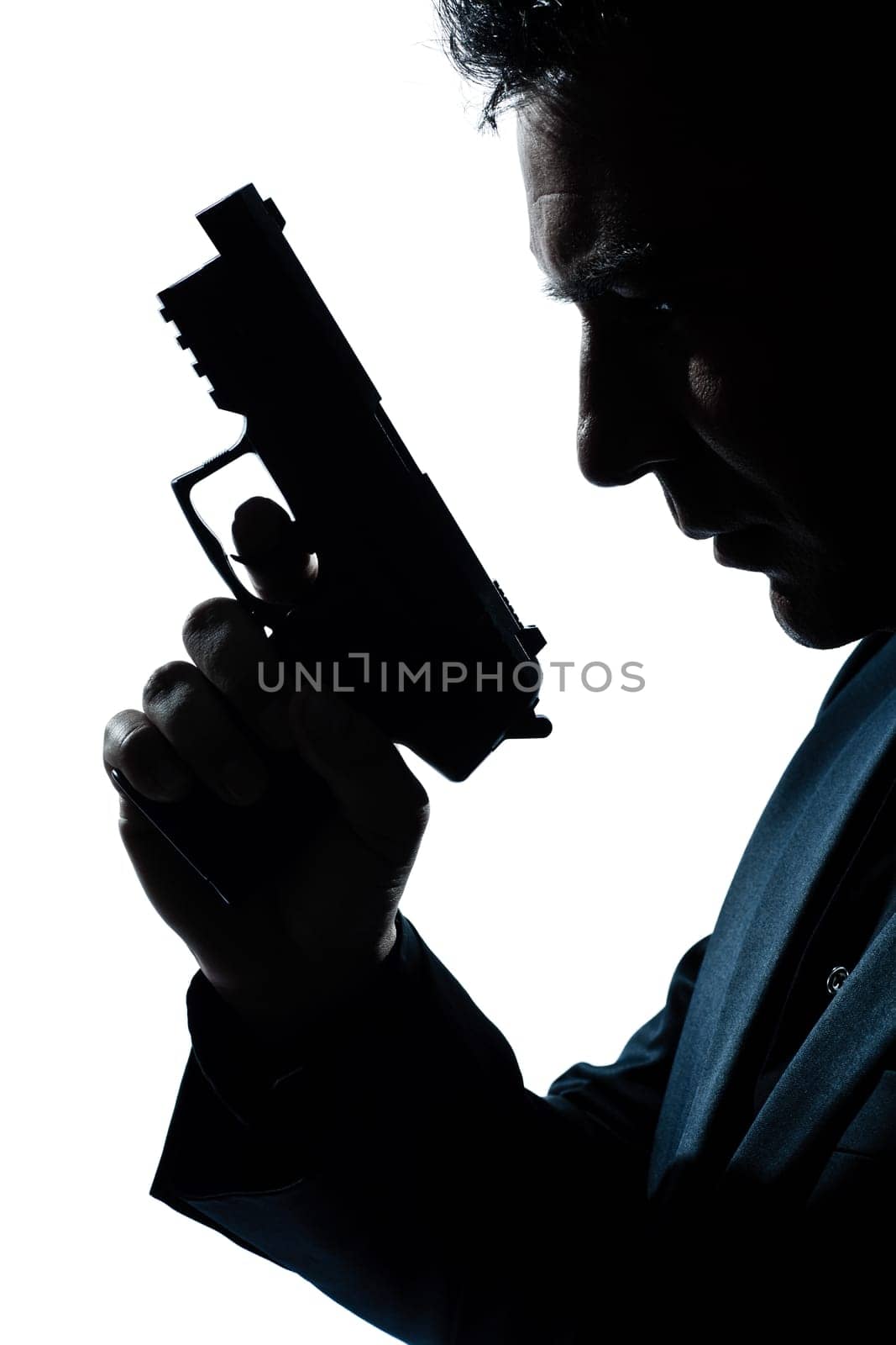 one caucasian spy criminal policeman detective man holding gun portrait silhouette in studio isolated white background