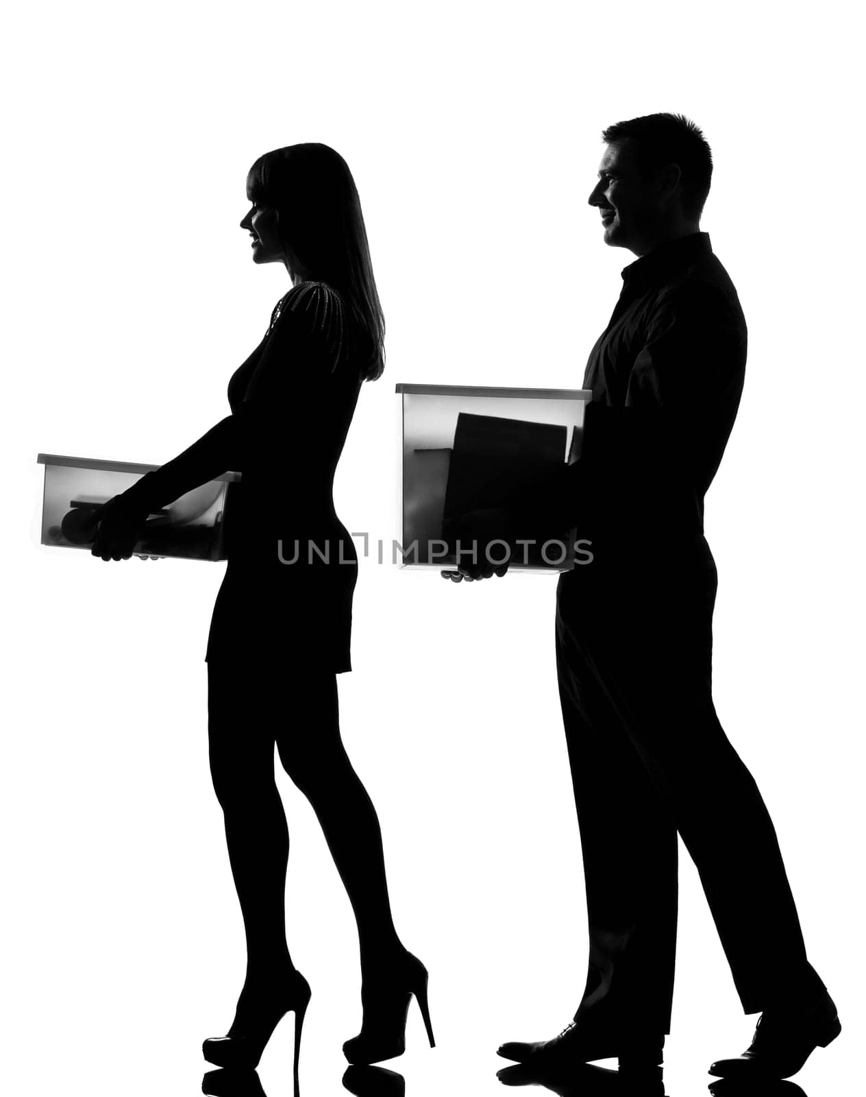 one caucasian couple man and woman walking carrying boxes happy full length in studio silhouette isolated on white background