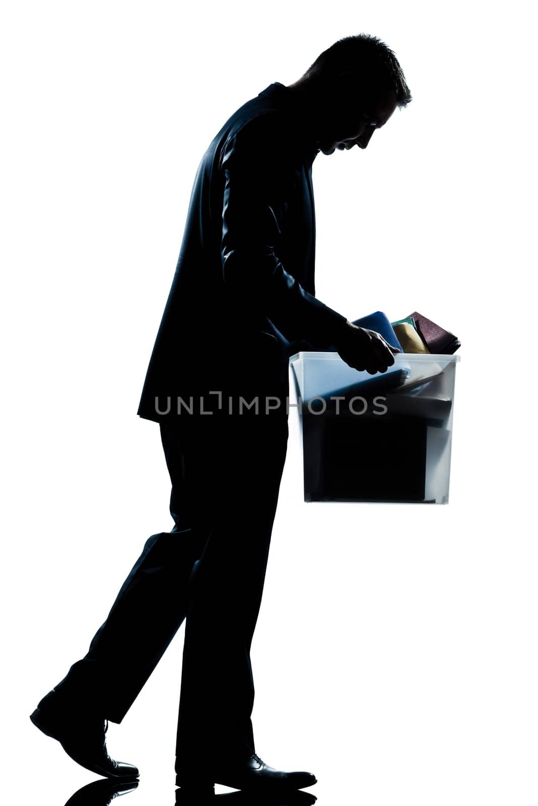 one caucasian man walking  full length fired carrying heavy box silhouette in studio isolated white background