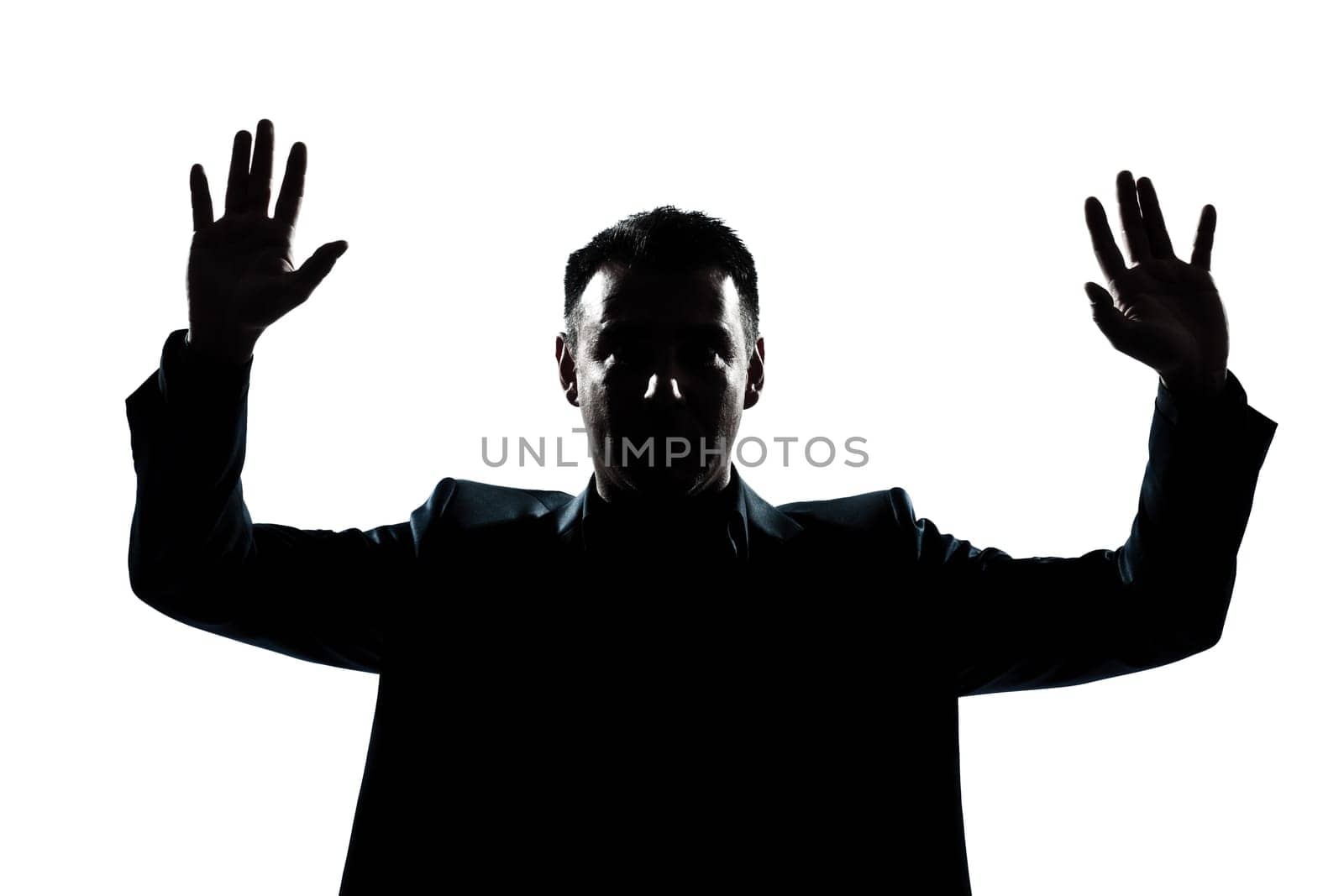 one caucasian man portrait silhouette hands up in studio isolated white background