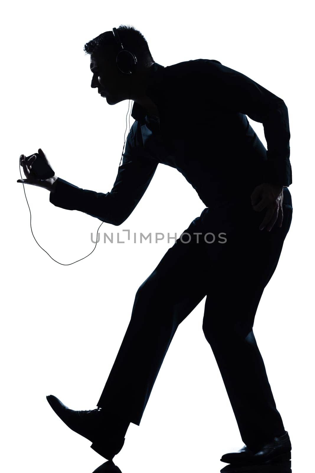 one caucasian man dancing happy listening to music full length silhouette in studio isolated white background