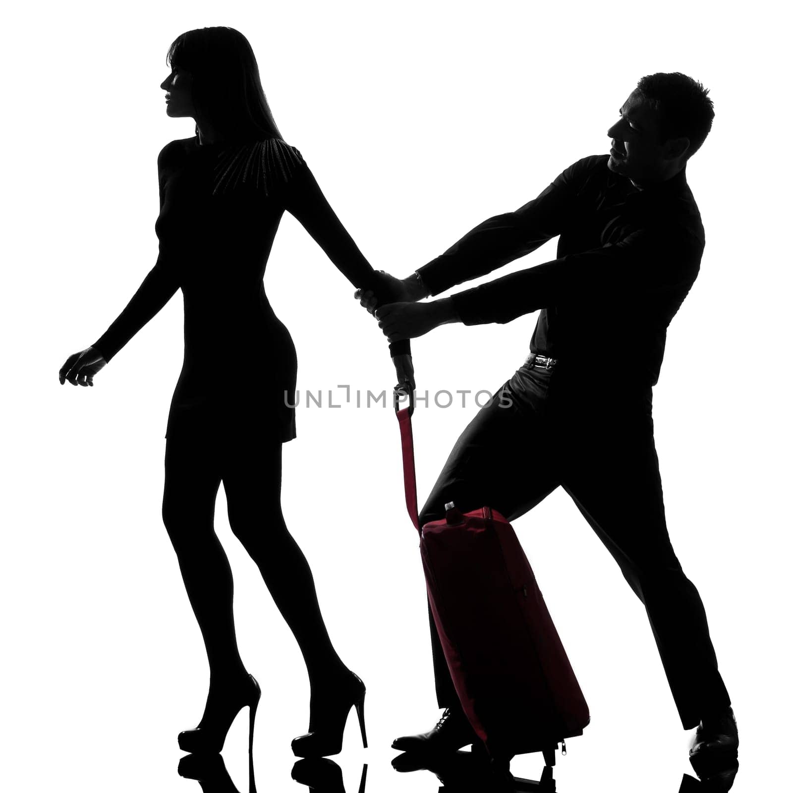 one caucasian couple dispute separation woman leaving and man holding back in studio silhouette isolated on white background