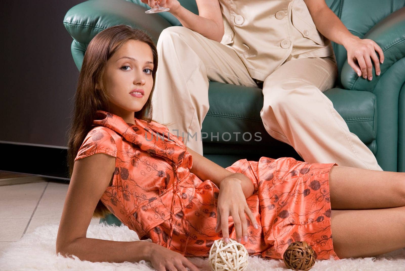 women portrait closeup, lying at floor and legs of other girl