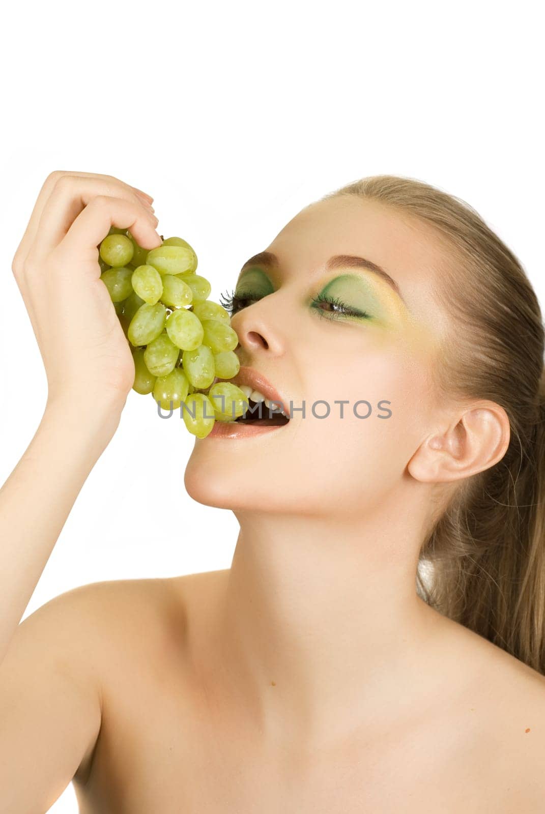 Pretty young woman with grape on the white background