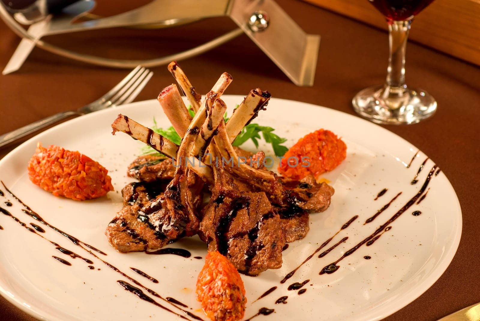 Roasted lamb chops with vegetables on decorated table