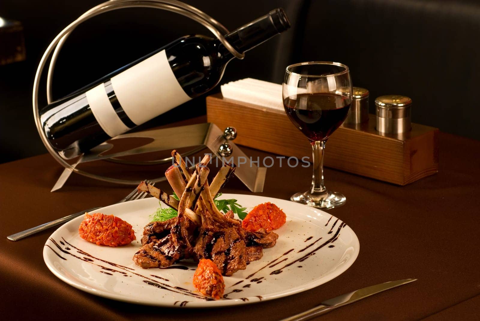 Roasted lamb chops with vegetables on decorated table