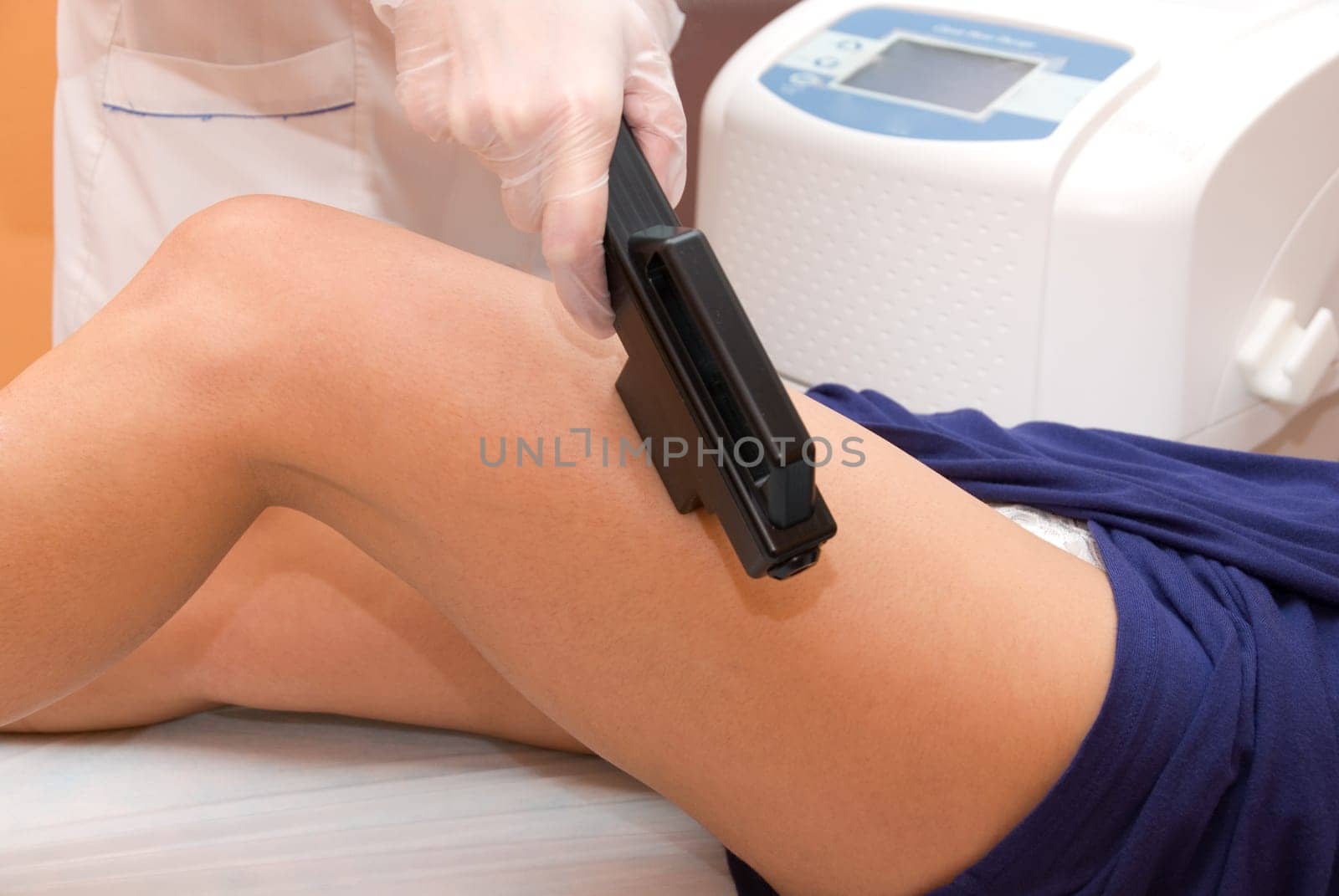 Laser epilation of leg in a modern beauty shop
