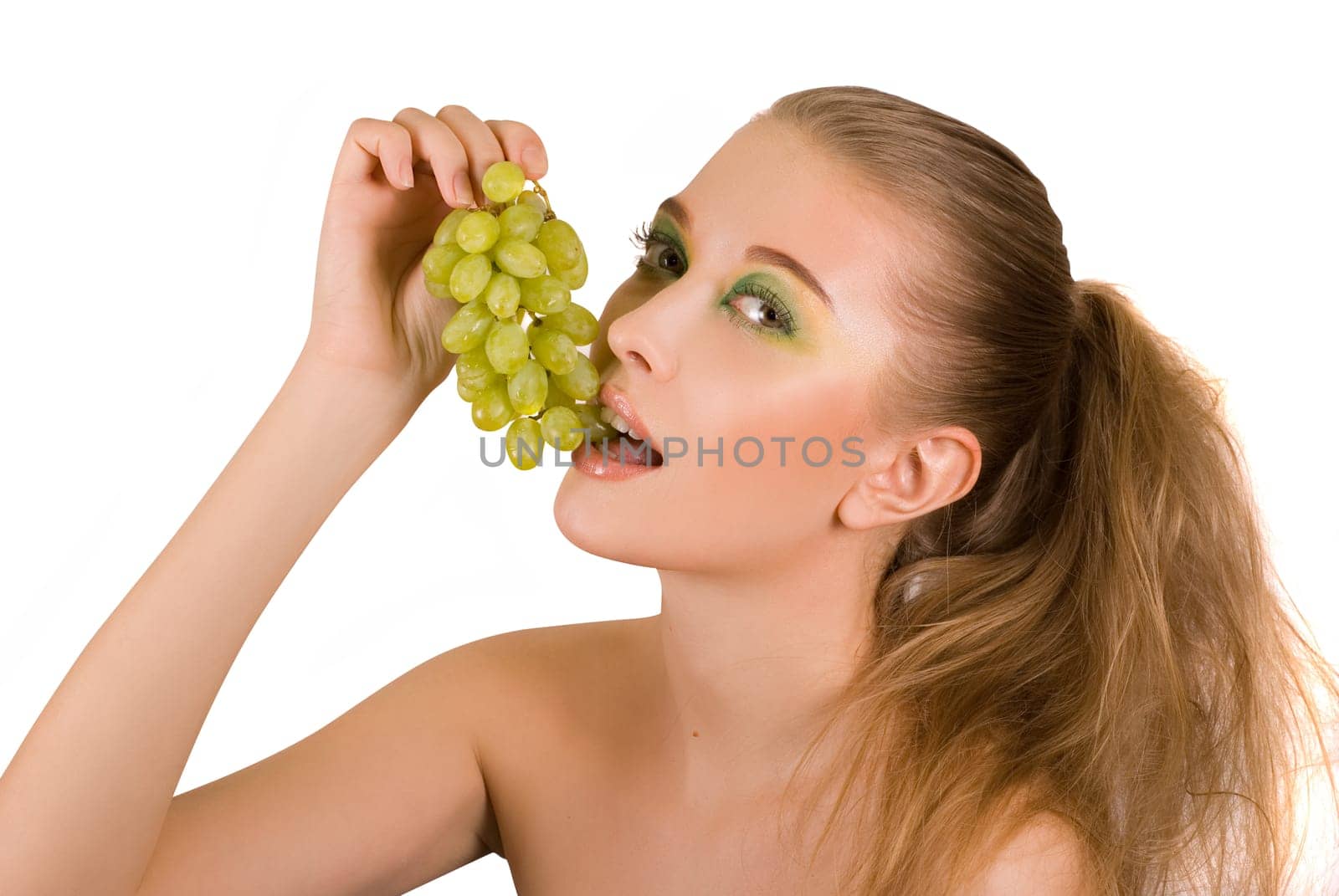 Pretty young woman with grape on the white background