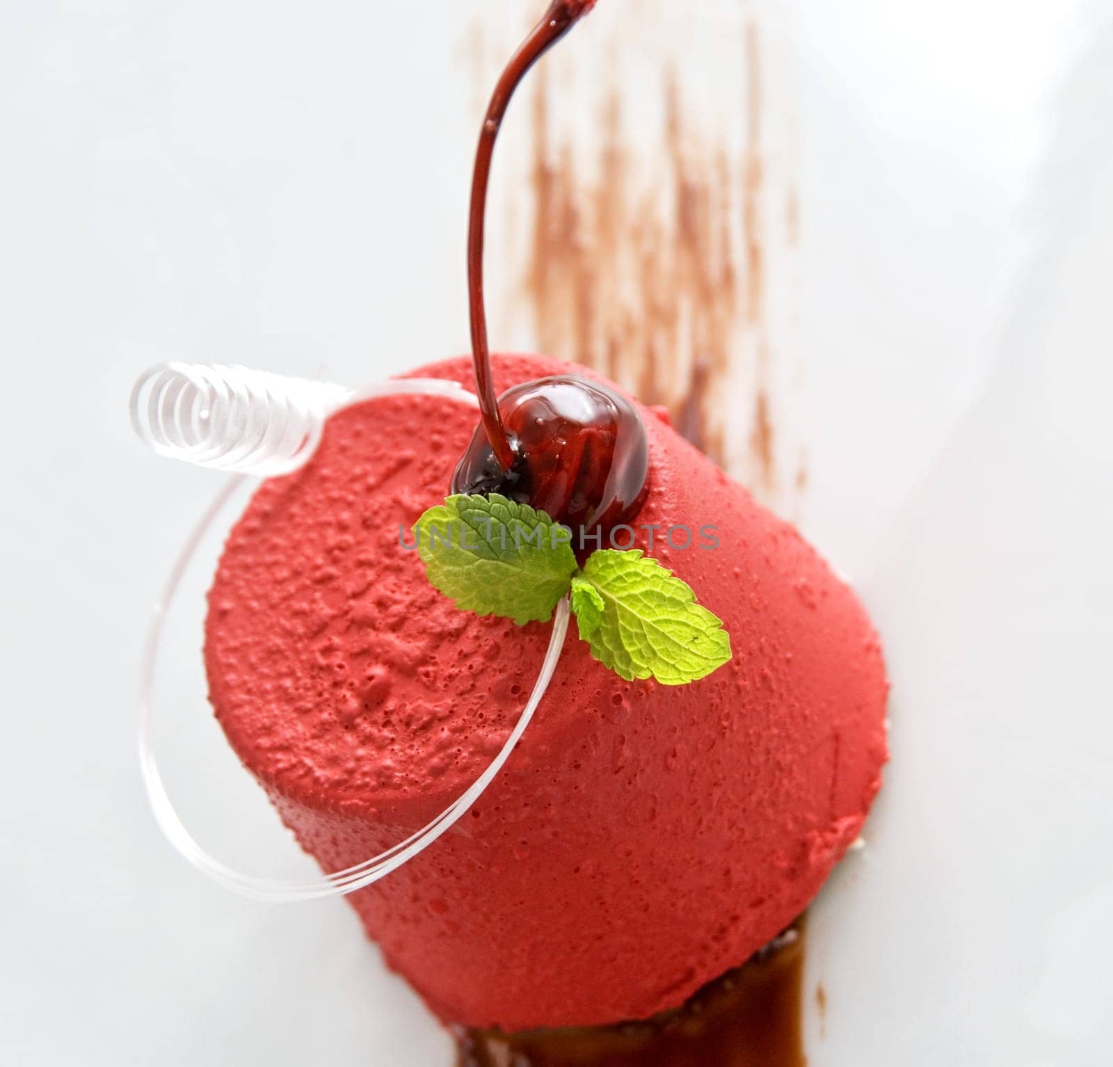 Tasty dessert of whipped cream, chocolate cherry, caramel and mint