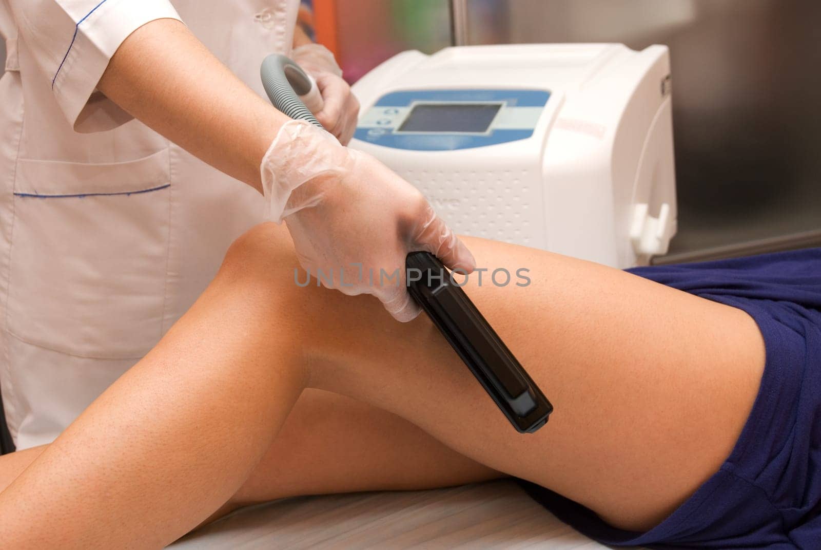 Laser epilation of leg in a modern beauty shop