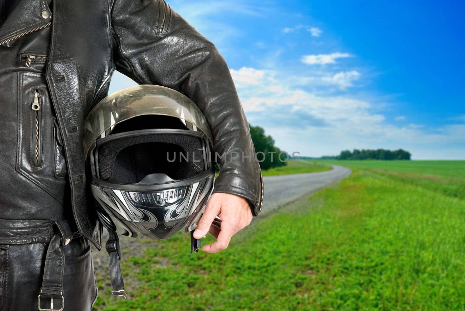 motorcycle biker with helmet closeup on a road
