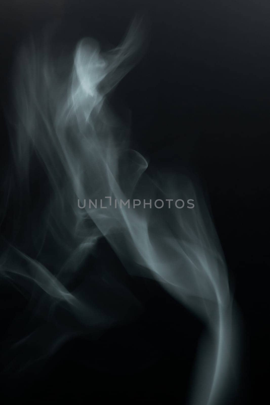 White and gray smoke against a black background