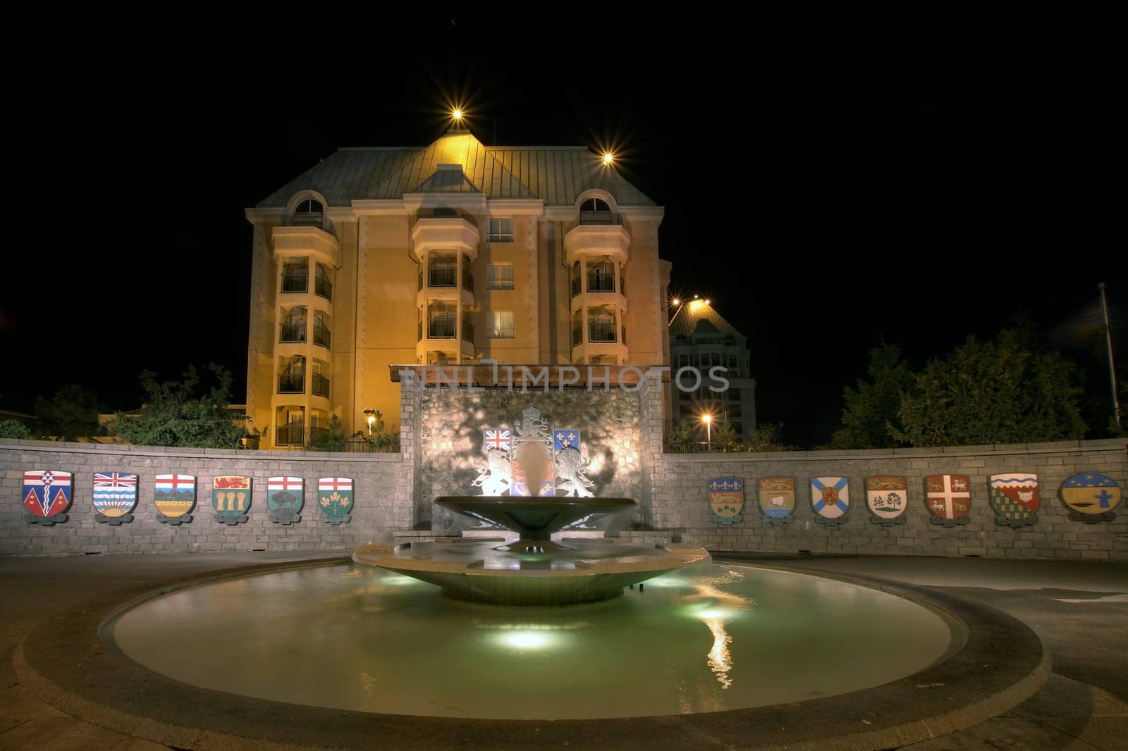 Confederation Garden Court Fountain in Victoria BC Canada with Code of Arms at Night