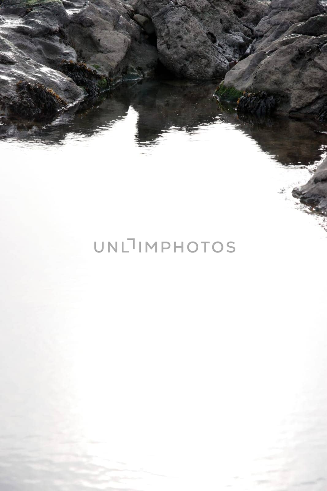 rocks on a beach in co kerry ireland on a crisp clear day