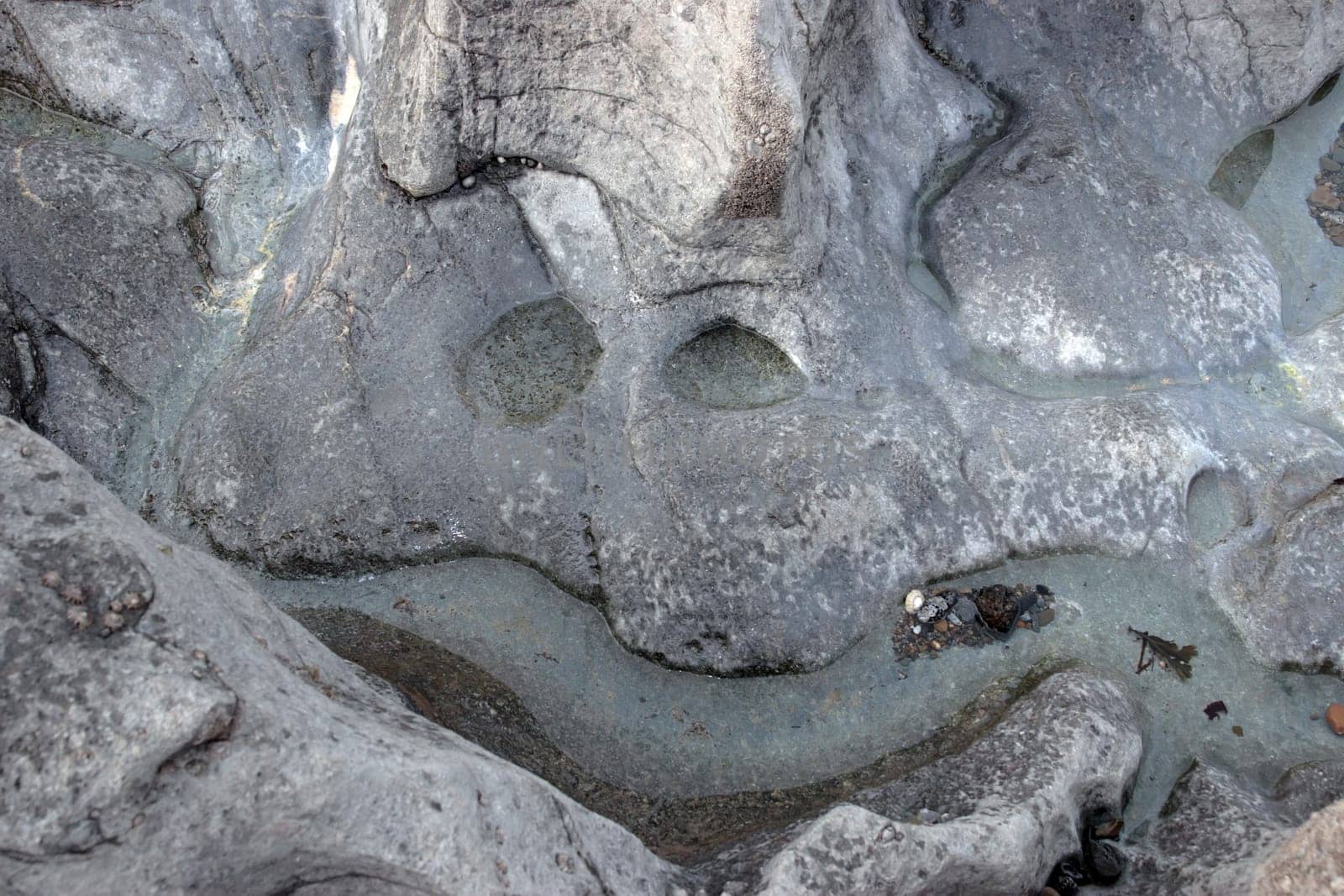 a smiley face shape on a rock pool surface