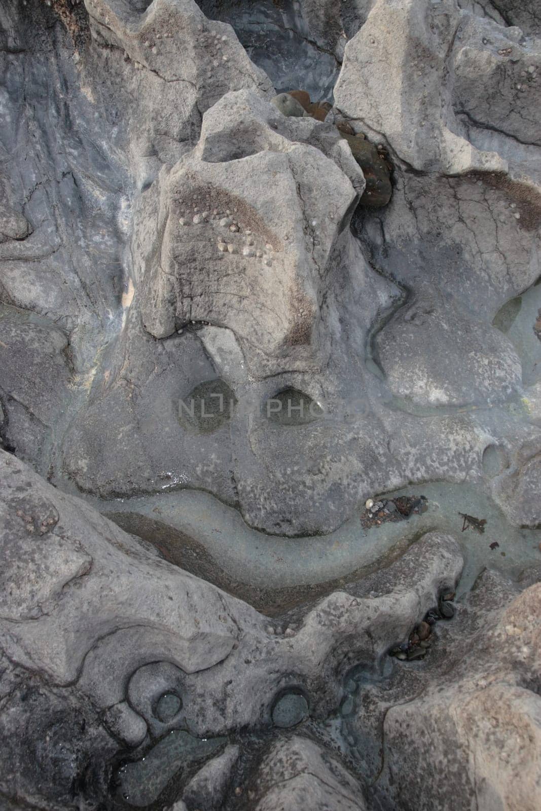 a smiley face shape on a rock pool surface