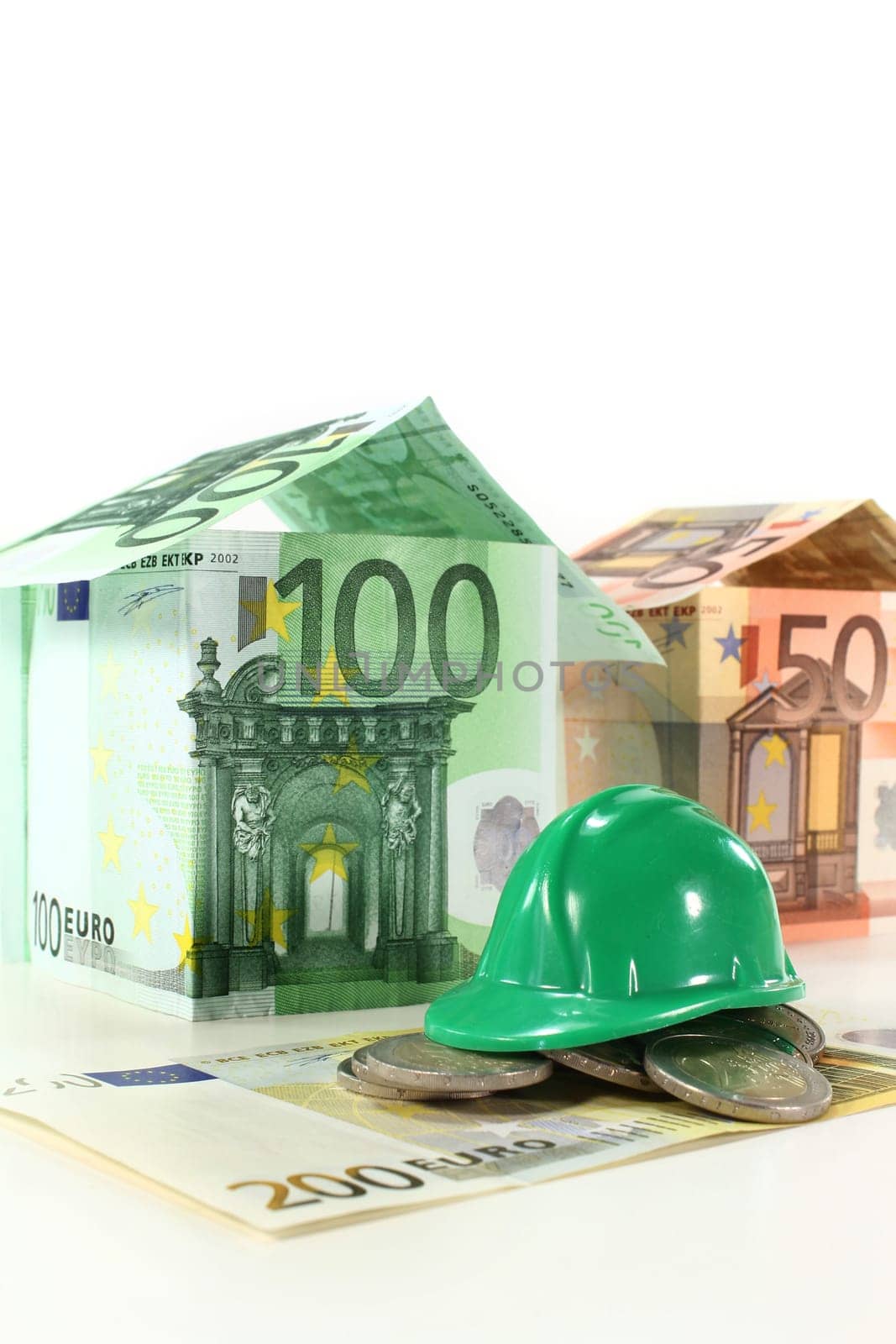 Construction helmet and euro bills against white background