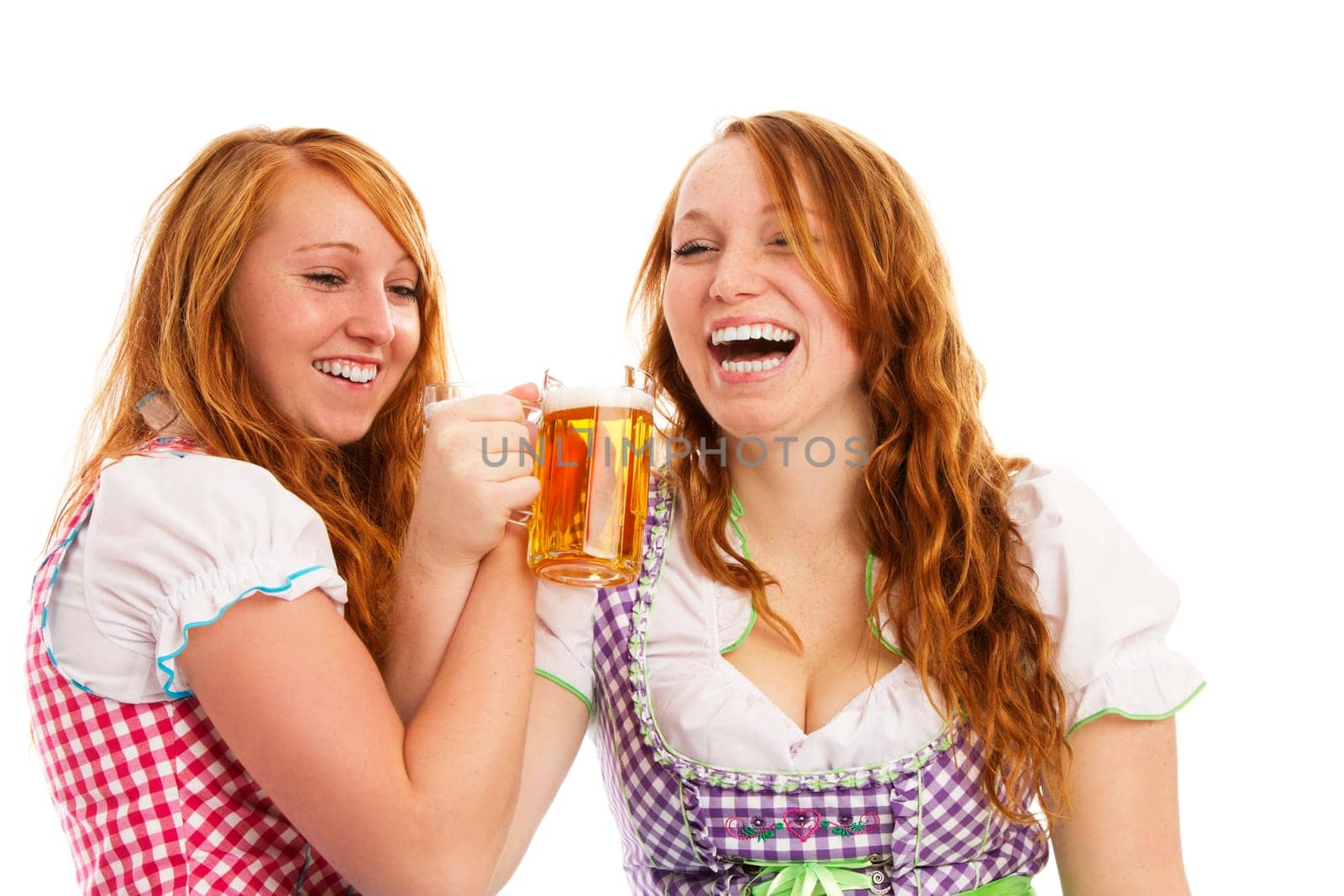 Two happy redhead women in dirndl celebrating on white background