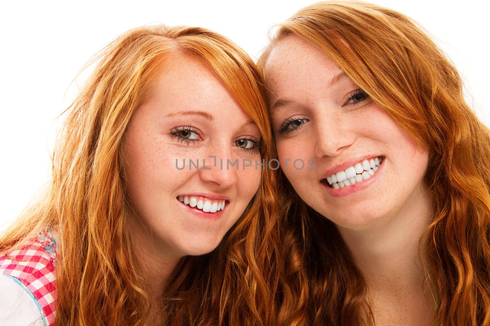 Two happy redhead women in dirndl on white background