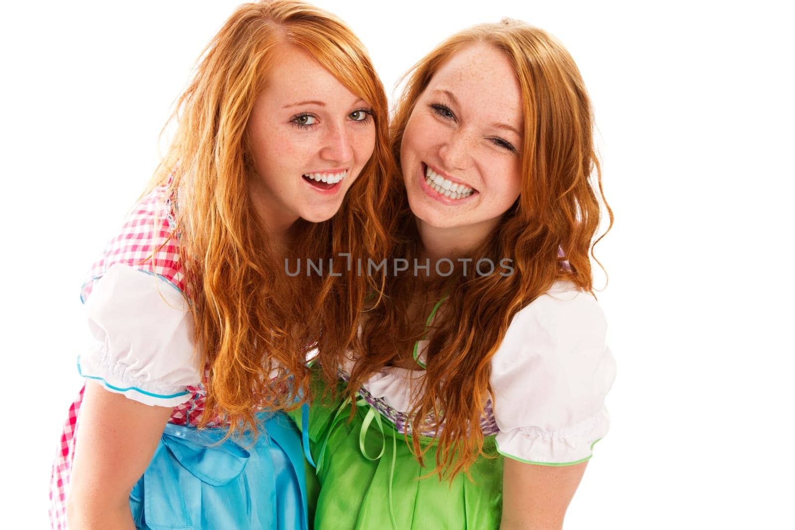Two laughing women in dirndl on white background