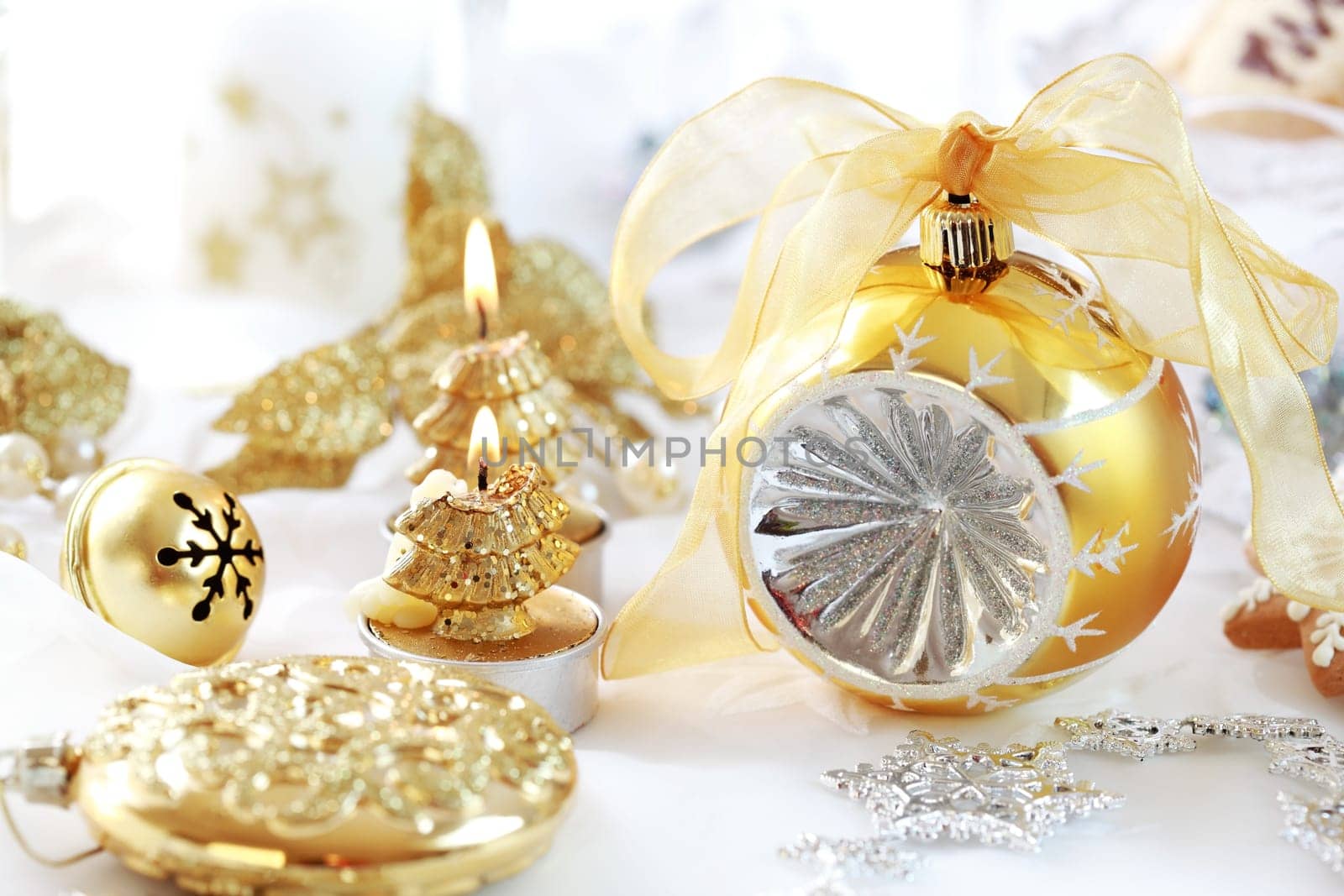 Christmas decoration with ball and candles in golden tone