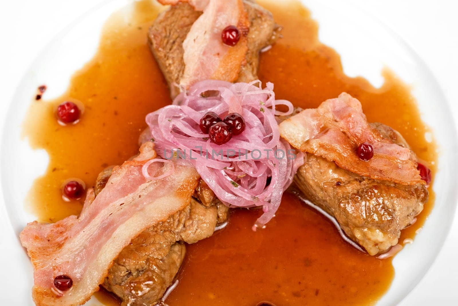 Roast pork meat with bacon, onion and cranberries